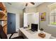 Home office with built-in shelving, a ceiling fan, and natural light filtering through the window with blinds at 328 Toldedo Rd, Davenport, FL 33837