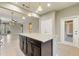 Bright, open floorplan with kitchen island, seamless flow to the living area, and elegant neutral tones throughout at 328 Toldedo Rd, Davenport, FL 33837