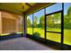 Relaxing screened patio features brick flooring and tranquil views of the lush green backyard at 328 Toldedo Rd, Davenport, FL 33837