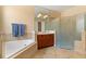 Bathroom with soaking tub and glass enclosed shower with tile surround at 3759 Eagle Isle Cir, Kissimmee, FL 34746