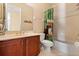 Bathroom features a wooden vanity, a baseball-themed shower curtain, and a toilet at 3759 Eagle Isle Cir, Kissimmee, FL 34746