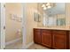 Bright bathroom with a single vanity and tile flooring next to the toilet at 3759 Eagle Isle Cir, Kissimmee, FL 34746