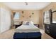 Bedroom features carpeted floors, a bed with white bedding, Marvel themed decorations, and two windows at 3759 Eagle Isle Cir, Kissimmee, FL 34746