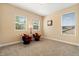 Bright bedroom with carpeted floors, three windows with blinds, and two chairs at 3759 Eagle Isle Cir, Kissimmee, FL 34746