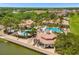 Aerial view of the community pool and clubhouse surrounded by lush landscaping at 3759 Eagle Isle Cir, Kissimmee, FL 34746