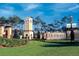 Welcoming community entrance with manicured landscaping and a decorative tower at 3759 Eagle Isle Cir, Kissimmee, FL 34746