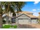 Charming two-story home with a well-manicured front yard and a three car garage with an appealing paver driveway at 3759 Eagle Isle Cir, Kissimmee, FL 34746
