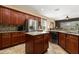 Kitchen with wooden cabinets, stainless steel appliances, and a center island at 3759 Eagle Isle Cir, Kissimmee, FL 34746