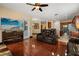 Inviting living room with hardwood floors, TV, access to lanai, and seamless flow to the kitchen at 3759 Eagle Isle Cir, Kissimmee, FL 34746