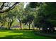 Lush, green community park offering open space for relaxation and recreation with trees and pond at 3759 Eagle Isle Cir, Kissimmee, FL 34746