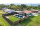Aerial view of the home's backyard including a pool, screened enclosure, and covered parking at 3824 Hickory Tree Rd, St Cloud, FL 34772