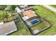 Aerial view of property featuring a screened pool, fenced yard, carport, and well-maintained landscaping at 3824 Hickory Tree Rd, St Cloud, FL 34772