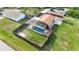 Aerial view of fenced backyard featuring a screened pool, covered parking, and green lawn at 3824 Hickory Tree Rd, St Cloud, FL 34772