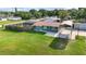 Aerial view showcasing the home, spacious lawn, and covered parking area at 3824 Hickory Tree Rd, St Cloud, FL 34772