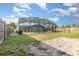 Backyard with screened pool, wood fence, grass, and utility shed at 3824 Hickory Tree Rd, St Cloud, FL 34772