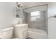 Bright bathroom features white vanity, tiled shower and tub, and modern fixtures at 3824 Hickory Tree Rd, St Cloud, FL 34772