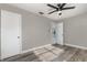 Bedroom featuring wood-look flooring, a ceiling fan, and access to another room at 3824 Hickory Tree Rd, St Cloud, FL 34772
