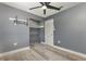 Bedroom features wood-look flooring, a ceiling fan, closet, and neutral paint at 3824 Hickory Tree Rd, St Cloud, FL 34772
