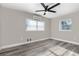 This bedroom has wood-look flooring, a ceiling fan, and mini-split air conditioning at 3824 Hickory Tree Rd, St Cloud, FL 34772