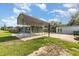 Backyard view featuring a carport, basketball hoop, shed, and grassy area at 3824 Hickory Tree Rd, St Cloud, FL 34772