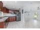 Modern kitchen features stainless steel appliances, tile floors, and stylish dark wood cabinetry at 3824 Hickory Tree Rd, St Cloud, FL 34772