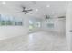 Spacious living room featuring sleek tile floors, recessed lighting, and large windows for natural light at 3824 Hickory Tree Rd, St Cloud, FL 34772