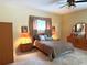 Comfortable bedroom featuring a ceiling fan and a large window providing natural light at 401 Chinahill Ct, Apopka, FL 32712