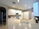 Bright kitchen with white cabinets, modern appliances, tile floors and laminate countertops at 401 Chinahill Ct, Apopka, FL 32712