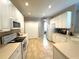 Bright kitchen with white cabinets, modern appliances, tile floors and laminate countertops at 401 Chinahill Ct, Apopka, FL 32712