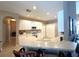 Bright kitchen with white cabinets, tile floors and bar seating at 401 Chinahill Ct, Apopka, FL 32712