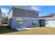 The back of the home, features a sliding glass door with access to the backyard at 443 Cool Summer Ln, Davenport, FL 33837