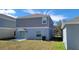 This angle shows a view of the back of the home and the backyard at 443 Cool Summer Ln, Davenport, FL 33837
