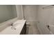 Well-lit bathroom with bathtub, shower, vanity, and sink offers a clean and modern space at 443 Cool Summer Ln, Davenport, FL 33837