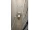 Half bathroom with a white toilet, gray tile flooring, and a door at 443 Cool Summer Ln, Davenport, FL 33837