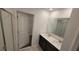 Bright bathroom features a double sink vanity and a separate shower room at 443 Cool Summer Ln, Davenport, FL 33837