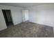 Spacious bedroom featuring gray carpeting and easy access to other rooms at 443 Cool Summer Ln, Davenport, FL 33837