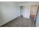 Bright bedroom with neutral gray carpeting, a closet, and an adjoining room at 443 Cool Summer Ln, Davenport, FL 33837