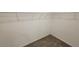 Walk-in closet with gray carpet and a metal shelving system for organized storage at 443 Cool Summer Ln, Davenport, FL 33837
