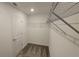 Spacious walk-in closet with carpet, metal shelves, and a door at 443 Cool Summer Ln, Davenport, FL 33837