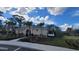 The community building features beautiful landscaping, a neutral color palette, and a welcoming entrance at 443 Cool Summer Ln, Davenport, FL 33837