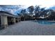 Inviting community pool area with stone accents on the cabana and ample space for residents to relax and socialize at 443 Cool Summer Ln, Davenport, FL 33837