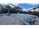 Resort style community pool featuring shaded lounge areas and a splash fountain for a luxurious living experience at 443 Cool Summer Ln, Davenport, FL 33837