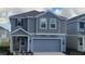 Charming two-story home with a well-maintained lawn and a two-car garage offers great curb appeal at 443 Cool Summer Ln, Davenport, FL 33837