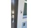 Modern front door features chrome hardware and a Ring doorbell for added security and convenience at 443 Cool Summer Ln, Davenport, FL 33837