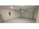 Clean and organized two-car garage with a functional garage door opener and concrete floor at 443 Cool Summer Ln, Davenport, FL 33837