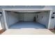 Clean, well-lit garage with painted floor, garage door opener, and exterior lighting at 443 Cool Summer Ln, Davenport, FL 33837