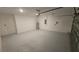 Spacious two-car garage with painted floor, utility door, and installed garage door opener at 443 Cool Summer Ln, Davenport, FL 33837
