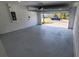 Open garage with a painted floor and installed garage door opener, providing easy access at 443 Cool Summer Ln, Davenport, FL 33837