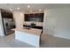 New kitchen with stainless steel appliances, central island, and dark wood cabinets offers modern elegance at 443 Cool Summer Ln, Davenport, FL 33837