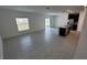 Bright open-concept space showcases tiled floors, connecting the kitchen and dining area with plenty of light at 443 Cool Summer Ln, Davenport, FL 33837